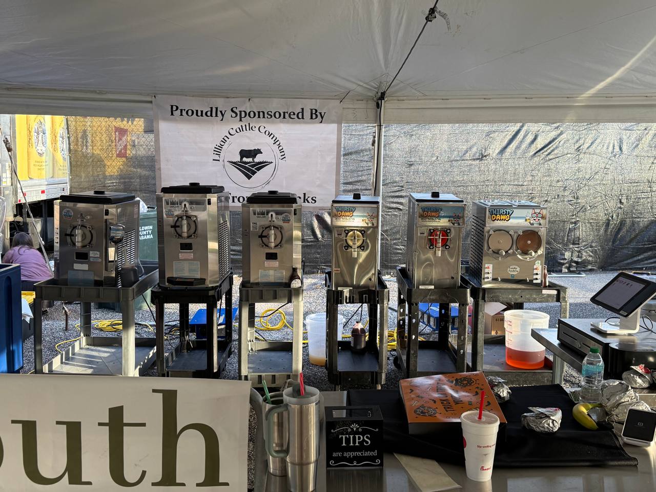 Thirsty Dawg stainless steel frozen drink machines set up under an event tent